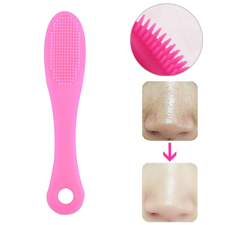 Light magenta silicone face cleansing brush with dense textured bristles and loop handle