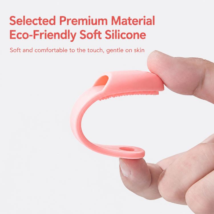 Hand holding a pink silicone nose brush with flexible curved textured cleaning edge
