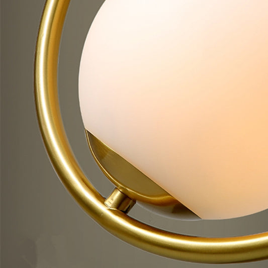 Close-up of round copper pendant lamp ring with frosted white glass diffuser