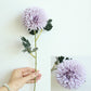 Simulated dandelion flower stem with light purple ball bloom and green leaves