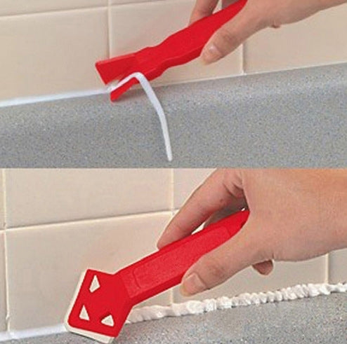 Red caulk and adhesive scraper tool used along tile grout edge