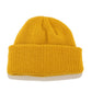 Yellow ribbed knit beanie with folded cuff and small top knot detail