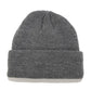 Dark gray ribbed knit beanie with folded cuff and small top knot detail