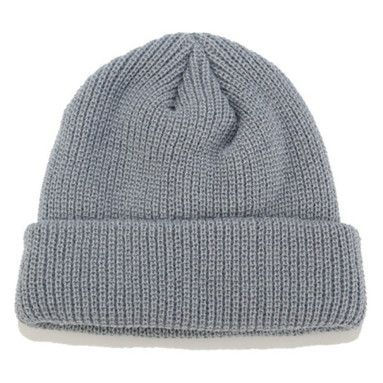 Light gray ribbed knit beanie with folded cuff and small top knot detail