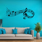Black music note wall decal with treble clef and curved staff lines on a blue wall