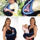 Newborn cross-body baby harness carrier with blue patterned lining, padded straps, and buckle
