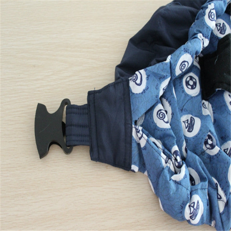 Newborn cross-body baby harness strap close-up with dark fabric and blue patterned ruffle