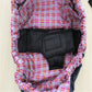 Newborn cross-body baby harness strap with red plaid outer, black center panel, and padding