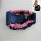 Newborn cross-body baby harness strap with red plaid ruffled lining and padded waist belt