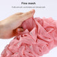 Pink bath brush head close-up with fine mesh scrubbing fabric