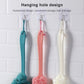 Hanging-hole bath brushes on hooks: teal, pink, and cream long-handled brushes