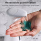 White automatic soap dispenser with open reservoir being filled by hand