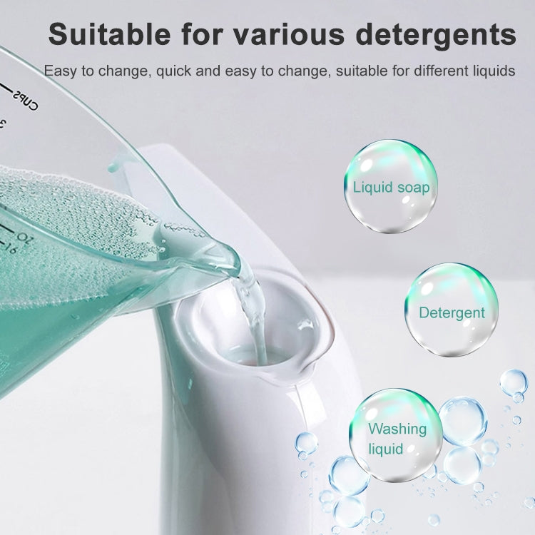 White automatic soap dispenser pouring clear liquid from the spout