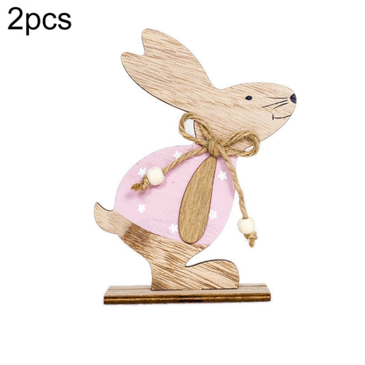 Wooden rabbit ornament with pink apron, twine bow, and star accents on base