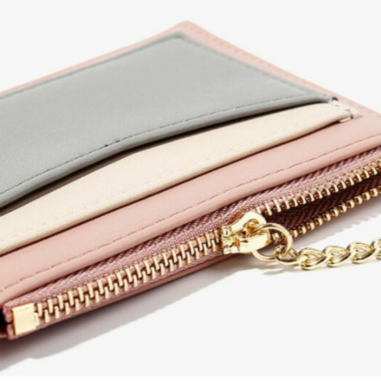 Gray-and-pink mini card wallet close-up with gold zipper and chain