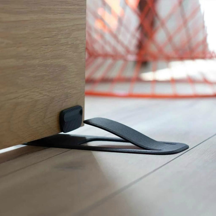 Black spring door stopper wedge for holding a door open
