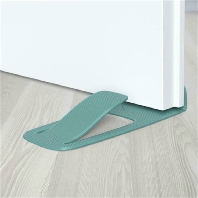 Teal spring door stopper wedge under a door corner