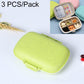 Portable straw pill storage box, wheat green closed clamshell with snap latch