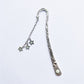 Silver metal bookmark with star charm chain and engraved handle