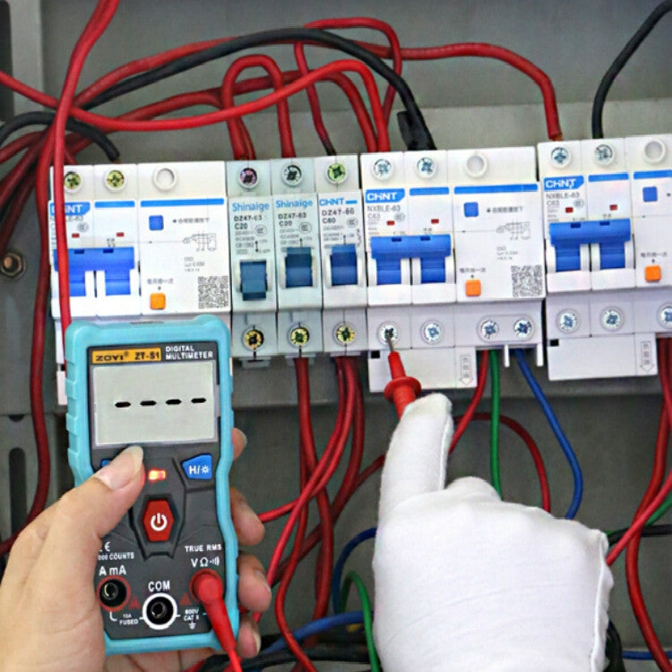 Teal mini digital multimeter held with red and black test leads for measurements