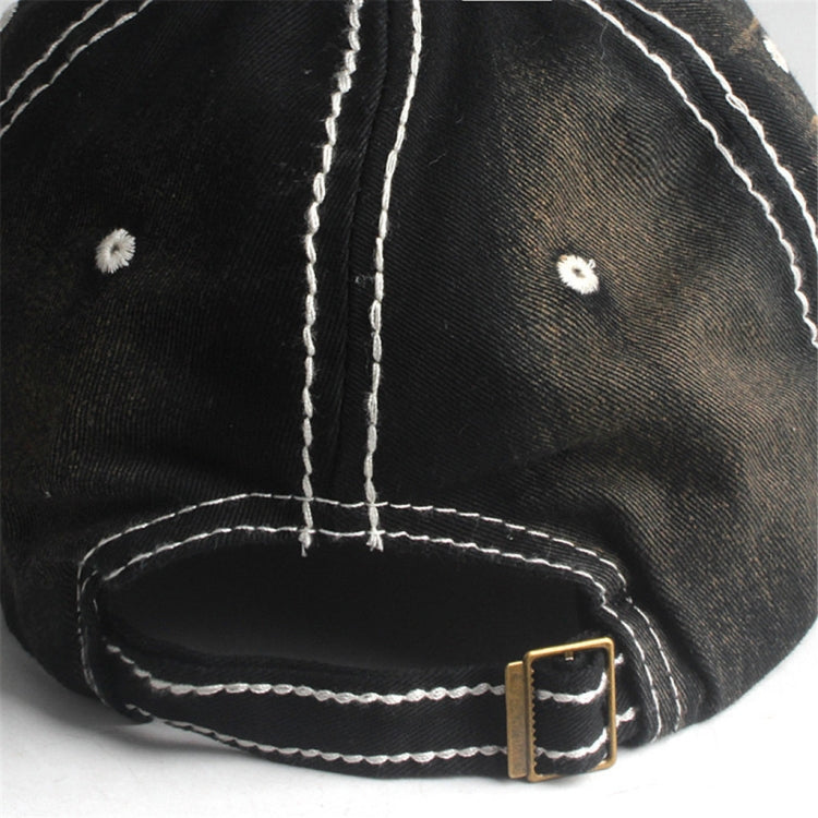 Black cap close-up: white contrast stitching and metal buckle on adjustable strap