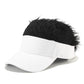White baseball cap with black shaggy wig hair on top and curved visor.
