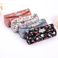 Floral makeup mirror cases set: peach, light blue, and black with clasps