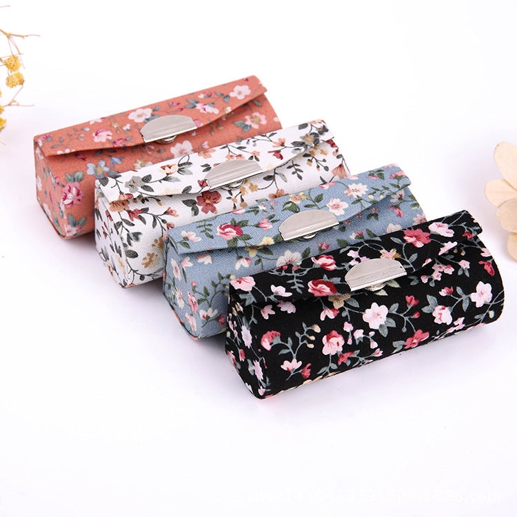 Floral makeup mirror cases set: peach, light blue, and black with clasps