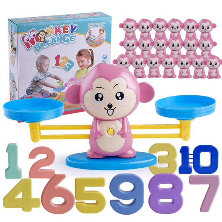 Pink monkey balance scale toy with number tiles and two blue balancing platforms