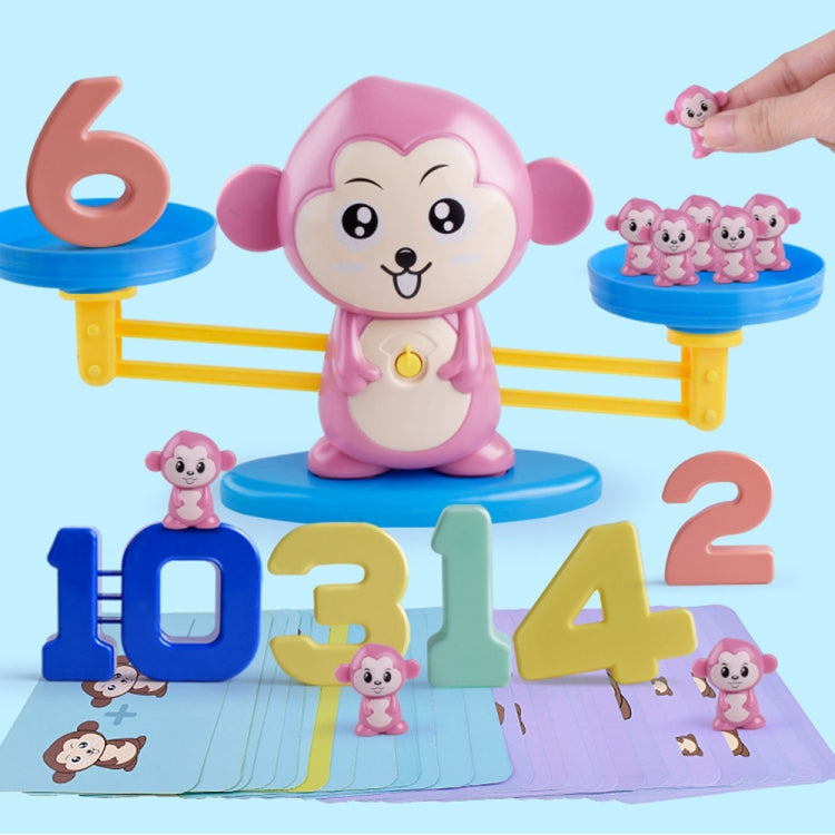 Pink monkey balance scale toy centered with blue balance trays and number tiles