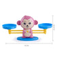 Pink monkey balance scale toy on round base with two blue platforms and yellow frame