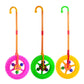 Set of three plastic walker push toys with purple, green, and yellow spinning wheels