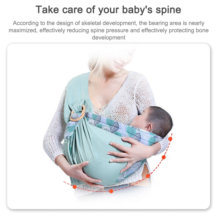 Mint green baby multifunctional strap worn by parent with baby inside