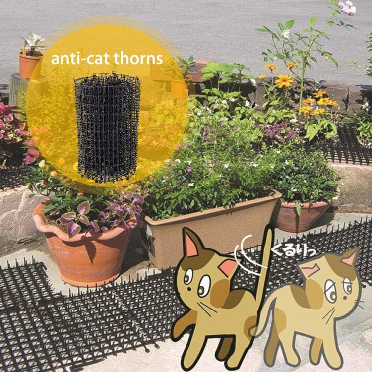 Black wire mesh pet deterrent barrier on garden walkway beside potted plants