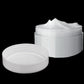 Mini 5ml cosmetic cream jars with white lids; one open with white cream