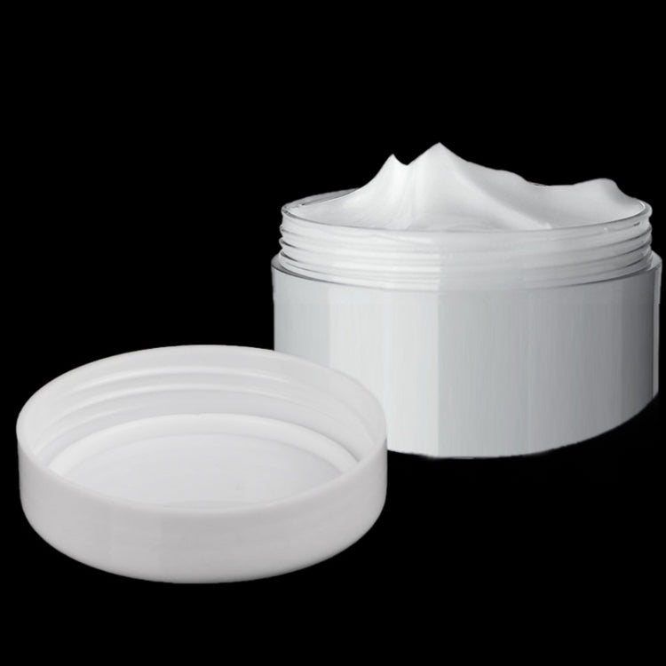 Mini 5ml cosmetic cream jars with white lids; one open with white cream
