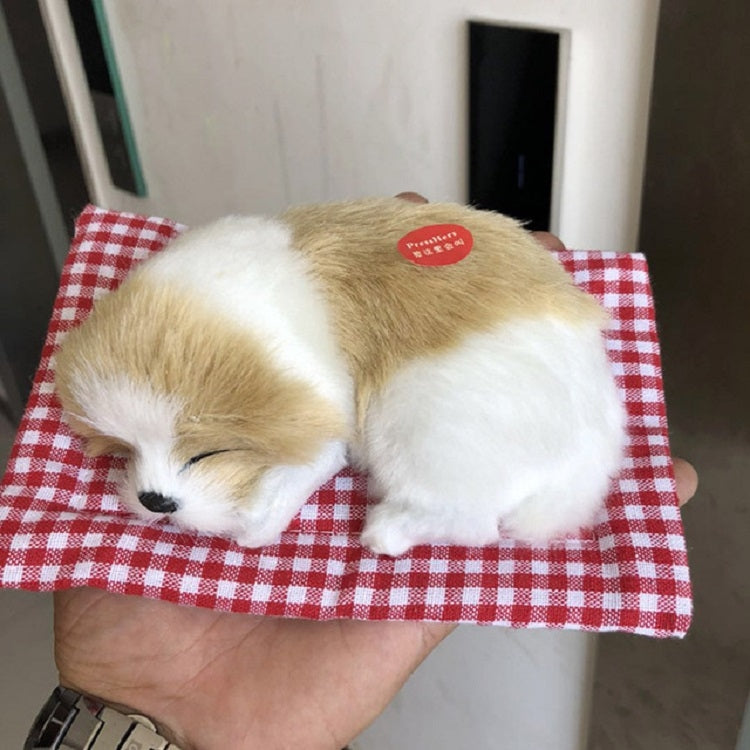 Sleeping plush dog ornament, tan and white fur, on red plaid blanket