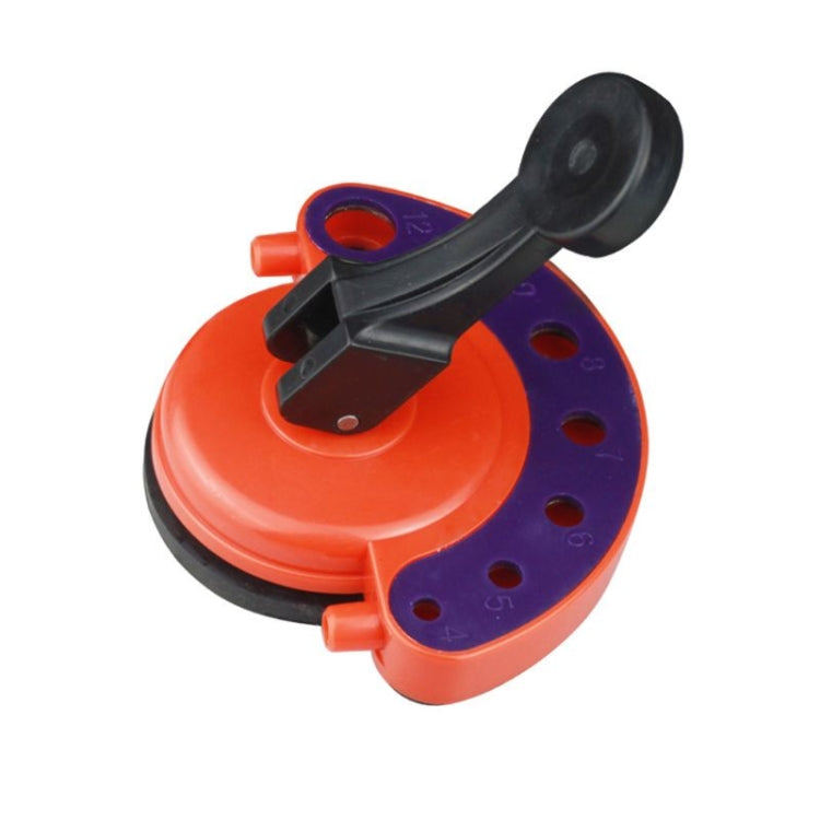 Orange and black glass hole cutter tool with suction base and hinged handle