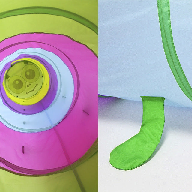 Close-up of cartoon face panel on a green and pink striped crawling tunnel, leg detail