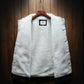 White sherpa-lined front with small label on denim jacket, no sleeves shown