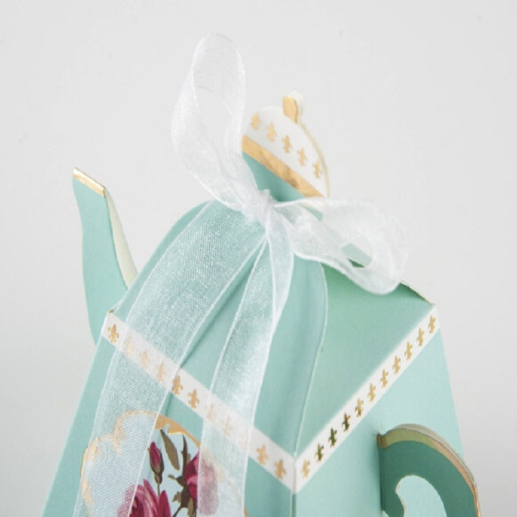 Light blue teapot-shaped candy box with floral side artwork and sheer tulle bow