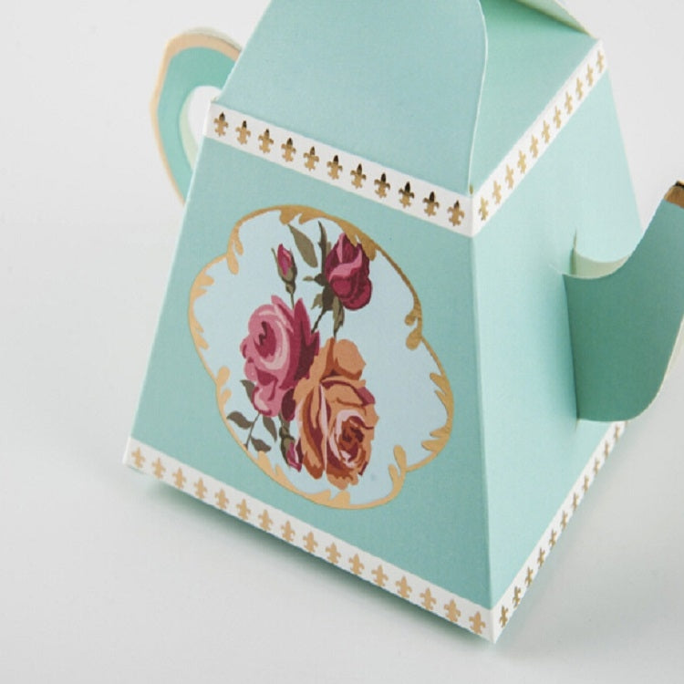 Light blue teapot-shaped candy box with floral front circle and decorative border trim