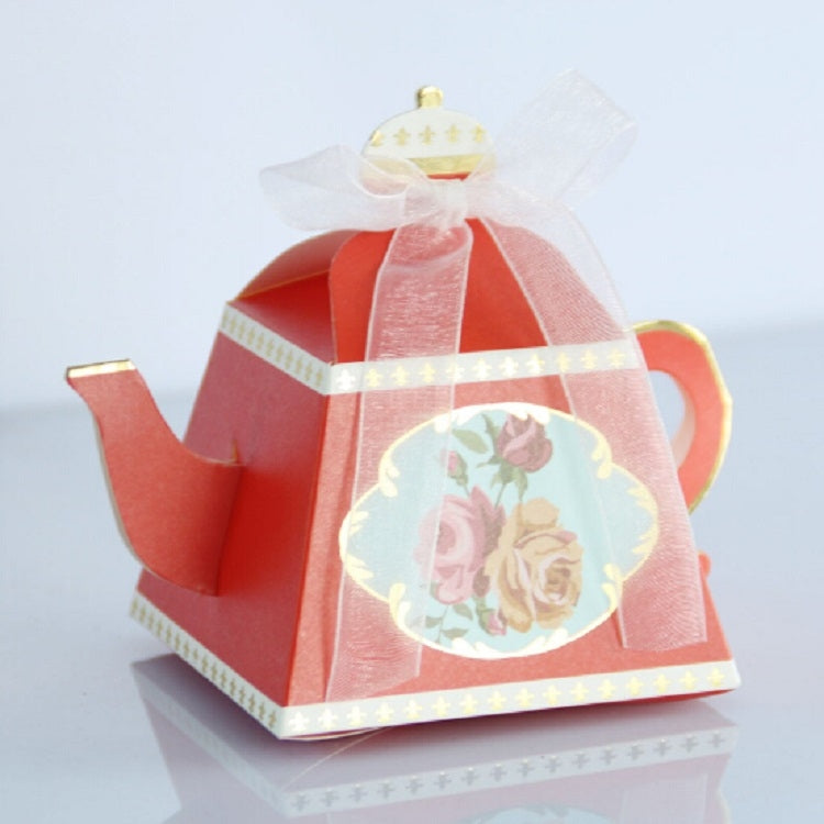 Red teapot-shaped candy box with floral medallion, pink ribbon, and tulle bow