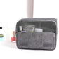 Grey toiletry storage bag with mesh top pocket and front zip compartment