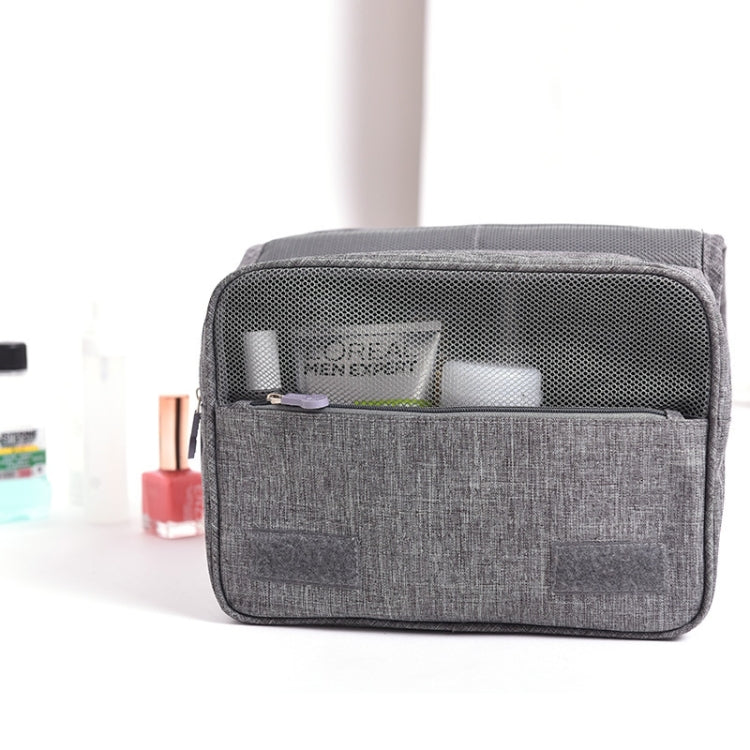 Grey toiletry storage bag with mesh top pocket and front zip compartment