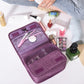 Purple travel organizer bag with mesh sections and multiple interior zip pouches