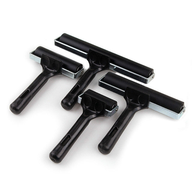 Set of black rubber ink rollers with metal brackets for print transfer