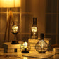 Bottle-shaped LED table lamp with warm glow, shown with a matching wire cage lamp