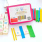 Montessori math tiles with colored rods and number cubes around a pink tablet case