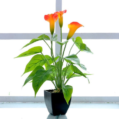 Artificial calla flower potted plant with orange-yellow blooms, green leaves, black square pot